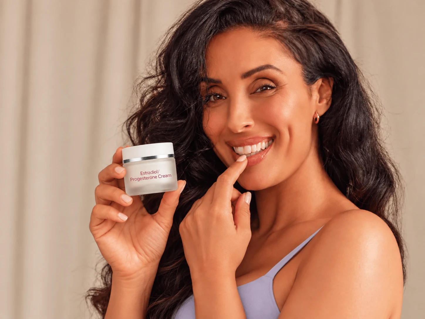 Woman holding prescription estradiol & progesterone cream